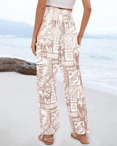 Detail of high-waisted bohemian print trousers with back view on beach setting