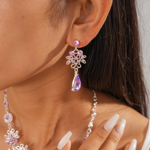 Detailed shot of vintage zircon flower and teardrop pendant necklaces in purple