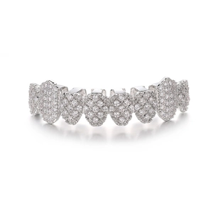 Macro shot of silver hip-hop grillz with pavé set clear crystals on white background