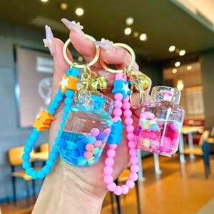 Detail of cute animal stacking ice cream keychain with liquid quicksand charm and star beads