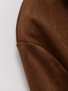 Detailed stitching and texture of brown faux suede leather jacket shoulder and sleeve seams