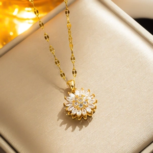 Elegant rotating sunflower pendant necklace in gold finish with sparkling crystals
