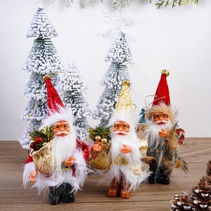 Three 5-inch plush Santa Claus figures in red, gold, and grey on a festive wood table