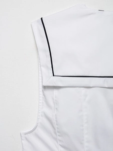 Detail of white nautical collar top featuring contrast black piping and fine stitching