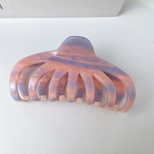 Detail of large octopus claw clip featuring pink and purple marble texture acetate