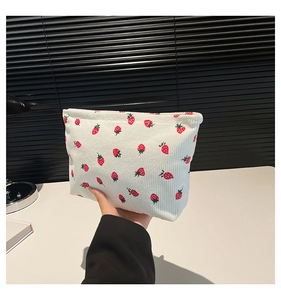 Detail of white corduroy strawberry tote bag featuring thick texture and cute patterns