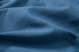 Macro shot of breathable blue cotton fabric texture and grain for casual shorts