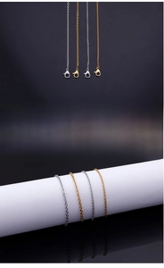 Close-up of 2mm stainless steel cable chains with lobster clasps in gold and silver