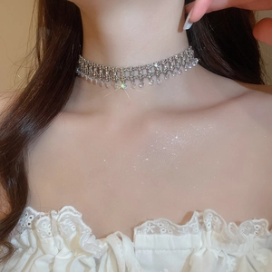 Silver fringe tassel necklace with sparkling zircons worn on female model neck