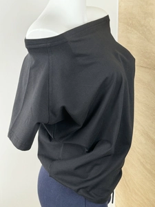Detail view of black off-shoulder short sleeve top with relaxed fit and soft cotton texture