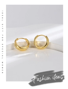 Detailed close-up of gold-plated thick hoop earrings with pavé set white zircon stones