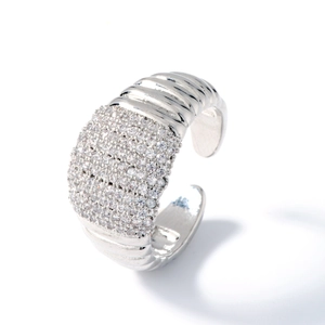 Silver geometric open ring with pavé zircons and striped texture on a white background