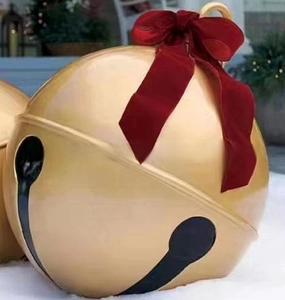 Detail of 60cm giant gold Christmas bell with red velvet bow for festive outdoor decor