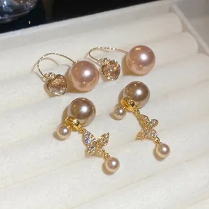 Elegant zircon heart and butterfly pearl earrings in a white velvet jewelry box