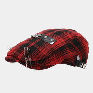 Detail of red and black plaid beret with silver studs, cross pendant and leather strap