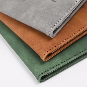 Close-up of RFID PU leather passport covers showing fine stitching and matte texture