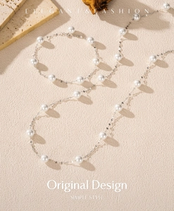 Detail of S925 sterling silver necklace and bracelet set with elegant white pearls