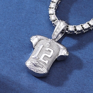 Macro view of silver-plated jersey pendant with rhinestone number 12 for hip-hop necklace