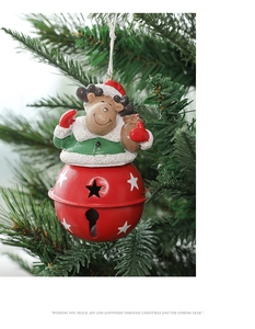 Close-up of a festive Christmas reindeer hanging ornament with a red star-cutout metal bell
