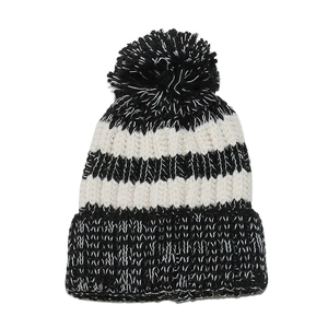 Detail of classic black and white striped knit beanie with a fluffy pom-pom top
