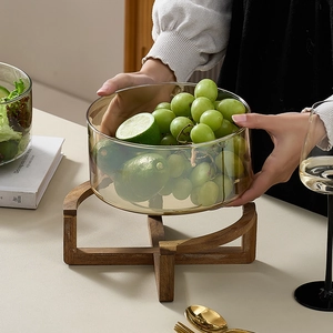 Amber glass fruit salad bowl with wooden stand featuring lemons and grapes