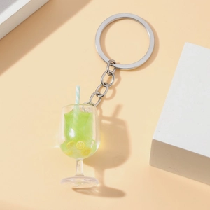 Detail of green miniature drink keychain with fake lemon slices and striped straw