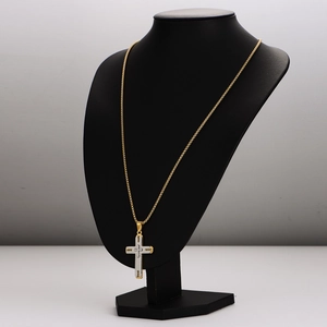 Gold and silver cross pendant necklace displayed on a professional black neck mannequin