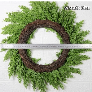 Detailed view of green cedar pine wreath with ruler measuring 50cm diameter size