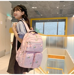Detailed side view of pink bear pattern backpack with multi-pocket student storage design
