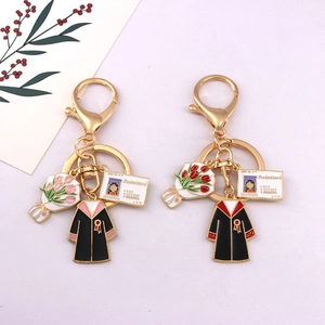 Golden graduation keychains with student card and graduation gown enamel charms