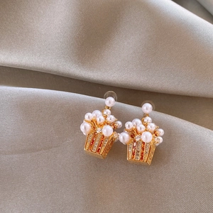Creative 18K gold plated popcorn earrings with white pearls and zircons on silk background