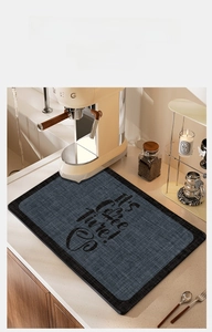 Macro shot of absorbent coffee mat with It's coffee time text on marble countertop