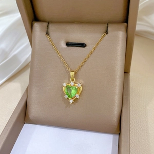 Detail of green heart zircon necklace with halo diamonds in a luxury jewelry gift box