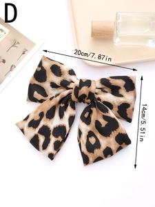 Top view of large leopard print satin bow hair clip with size dimensions shown