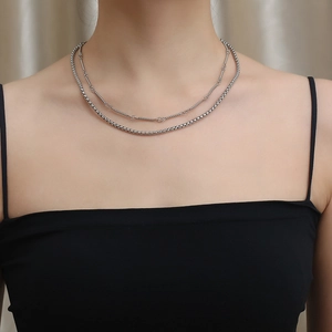 Detail shot of vintage double-layer silver box chain necklace on model neck