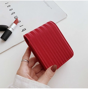 Close-up of red vertical quilted leather mini cosmetic pouch with mirror for lipsticks