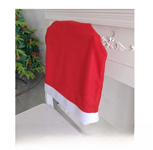 Side view of red velvet Christmas chair cover with white trim in festive room setting