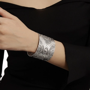 Vintage silver-tone wide cuff bracelet with ethnic sun pattern and geometric embossing