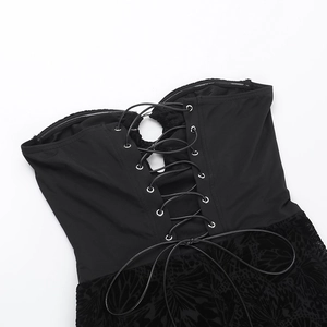 Detailed macro view of black lace jumpsuit with silver eyelets and cross-lacing design