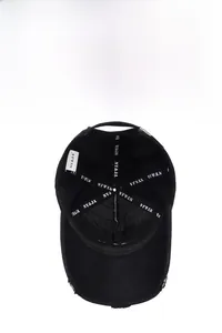 Detail of vintage black baseball cap showing reinforced inner tape and distressed brim