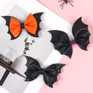 Halloween bat wing hair clips for girls in black and orange leather with glitter accents