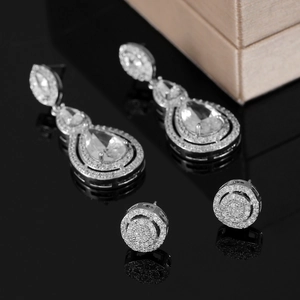 Close-up of luxury pear-cut zircon earrings with pave rhinestones on black background