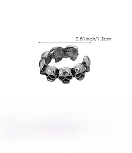 Macro shot of vintage silver skull earring with textured surface and exact dimensions