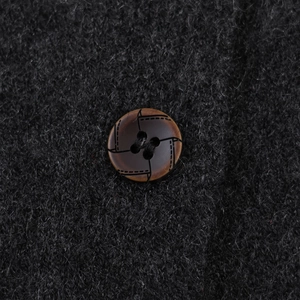 Chic knit cardigan with embroidered bow featuring soft fuzzy texture and marble button detail
