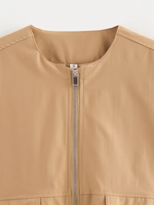 Detail of metal zipper and S-size label on the collar of a camel outdoor flight jacket