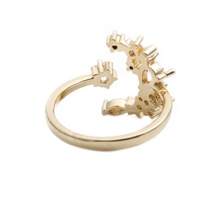 Adjustable gold star and moon open ring with cubic zirconia stones on white background
