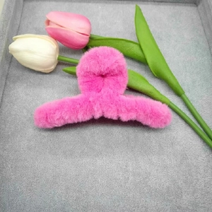 Plush 11cm rose pink shark hair claw clip for women on a grey velvet tray display