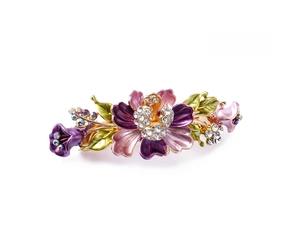 Detail of purple enamel flower hair clip with gold metal base and sparkling rhinestones