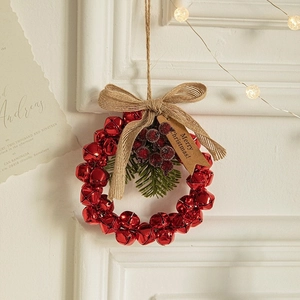 Red Christmas bell wreath with burlap bow, red berries and pine needles for tree decor