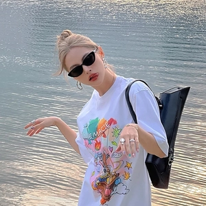 White cat-eye sunglasses for women styled with casual summer outfit by the water